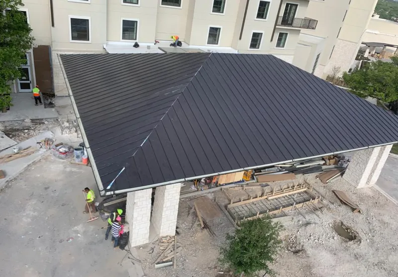 Metal roofing installation team working on a commercial building in Mauldin